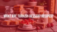 Assortment of Turkish desserts including baklava, Turkish delight, and creamy puddings, beautifully arranged on a wooden table, warm lighting, vibrant colors, realistic.