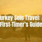 A solo traveler admiring the ancient ruins of Ephesus, warm sunset lighting, vibrant Turkish landscape, realistic and inviting.