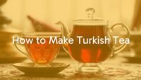 A traditional Turkish tea set with a glass tulip-shaped cup and teapot, steaming hot tea, cozy background, warm and inviting atmosphere, realistic style.