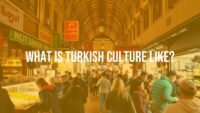 Vibrant Turkish bazaar scene with colorful stalls, people sharing food, traditional architecture, warm lighting, lively atmosphere, cultural fusion.