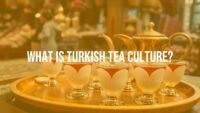 A traditional Turkish tea setting with tulip-shaped glasses, steaming tea, and a copper tea pot on a wooden tray, vibrant bazaar background, warm and inviting atmosphere, realistic.