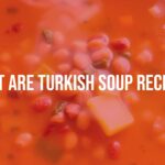 A steaming bowl of Turkish soup with lentils and fresh vegetables, golden broth, warm and inviting colors, rustic table setting, soft lighting, realistic.